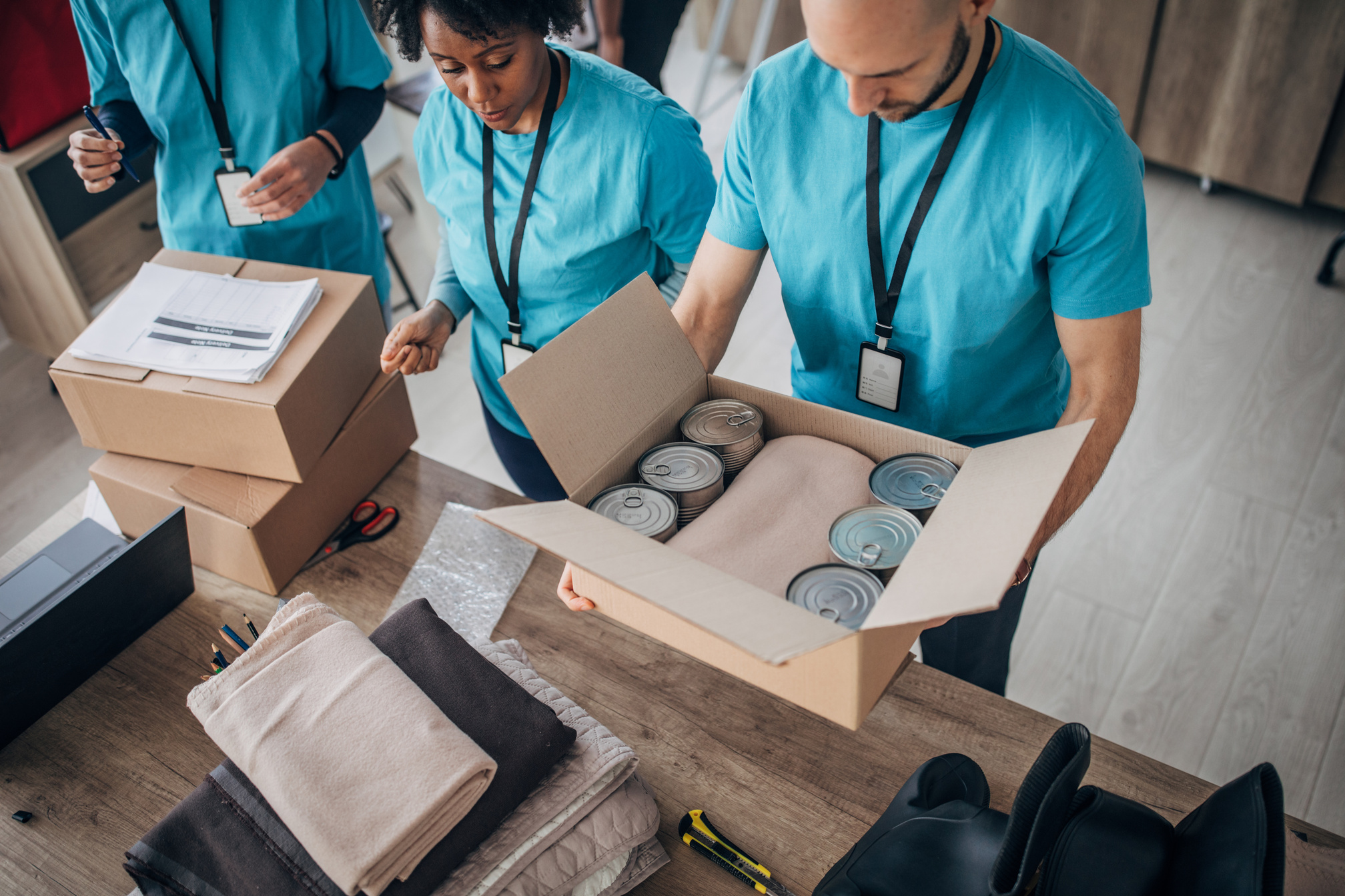 Volunteers packing donation boxes in charity food bank